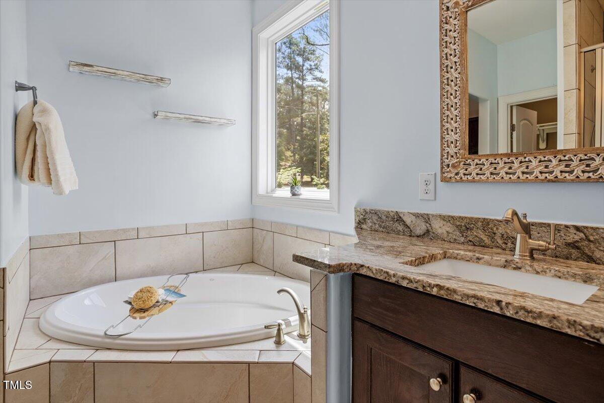 1422 Gormly Circle Sanford, NC 27330 - Photo 20 of 59 a bathroom with a granite countertop sink and a mirror