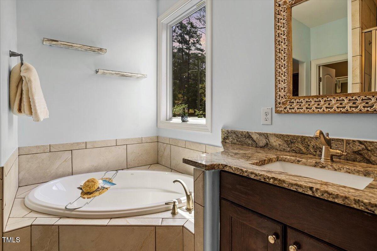 1422 Gormly Circle Sanford, NC 27330 - Photo 21 of 59 a bathroom with a sink and a mirror