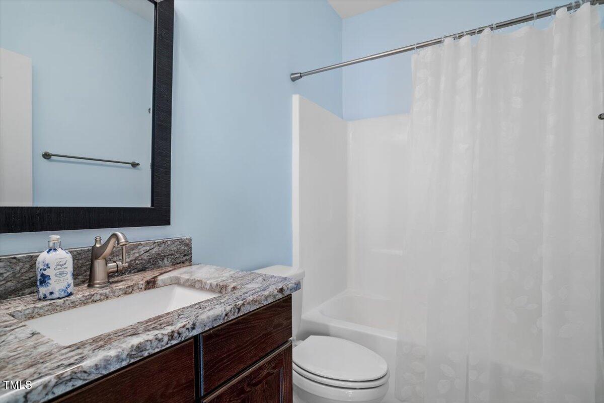 1422 Gormly Circle Sanford, NC 27330 - Photo 24 of 59 a bathroom with a granite countertop sink and a mirror