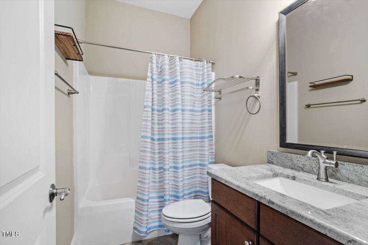 1422 Gormly Circle Sanford, NC 27330 - Photo 33 of 59 a bathroom with a granite countertop sink toilet and shower
