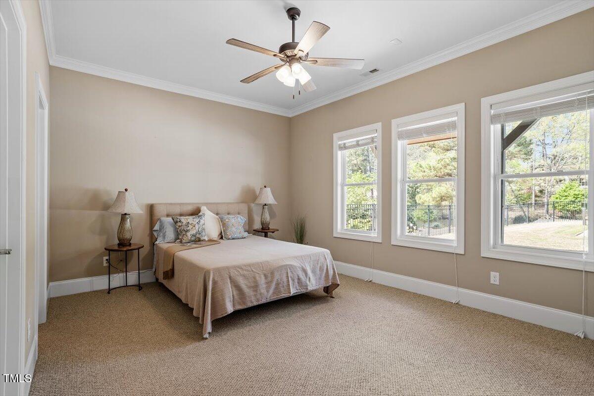 1422 Gormly Circle Sanford, NC 27330 - Photo 36 of 59 a bedroom with a bed chandelier and a window
