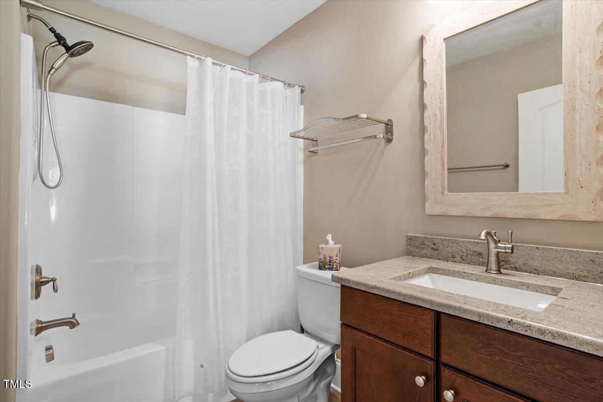 1422 Gormly Circle Sanford, NC 27330 - Photo 37 of 59 a bathroom with a granite countertop sink toilet and shower
