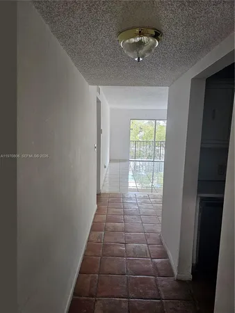 a view of a hallway with windows