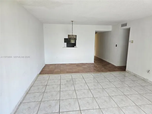 a view of a livingroom with an empty space and a window