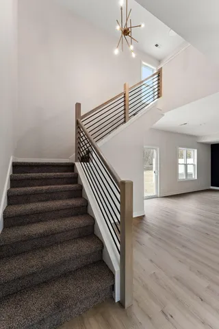 a view of entryway and hall with wooden floor