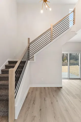 a view of entryway and hall with wooden floor