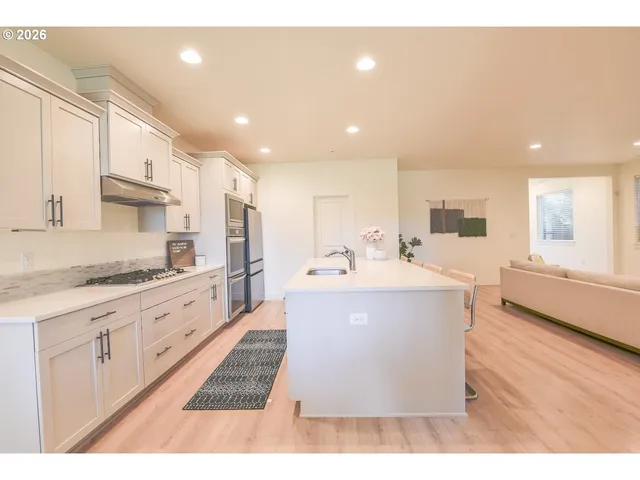 a large white kitchen with a large window