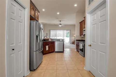 a kitchen with stainless steel appliances granite countertop a stove top oven a sink dishwasher and a microwave oven with cabinets