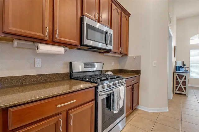 a kitchen with kitchen island granite countertop a stove and a sink