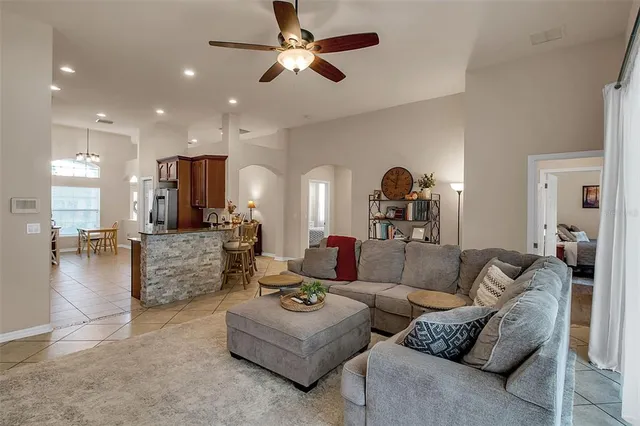 a bedroom with a bed a couch and a window