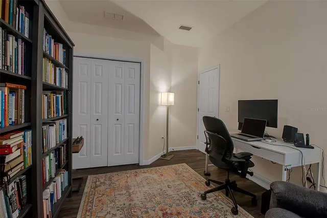 a bed room with a bed and a chair