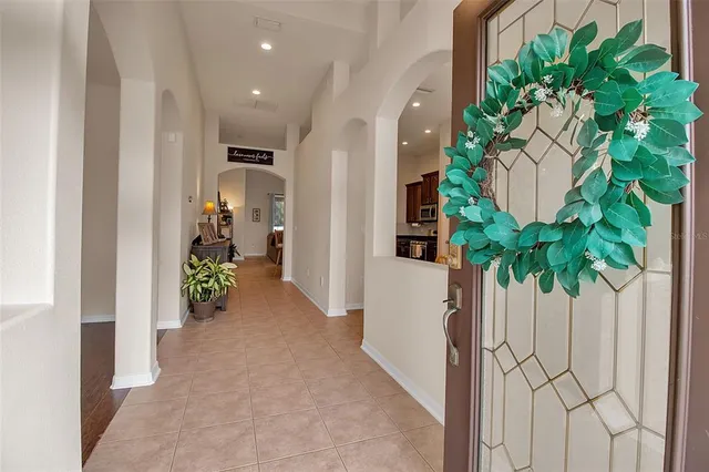 a view of a hallway with plant in front of it
