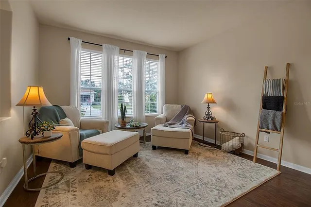 a view of a dining room with furniture and wooden floor
