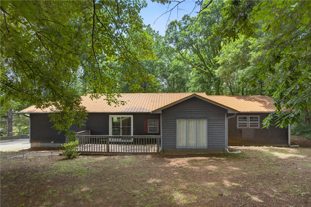 230 Dickard Road Seneca, SC 29672 - Photo 19 of 25 A tranquil woodland setting surrounds this residence, featuring a sizable deck for outdoor enjoyment.