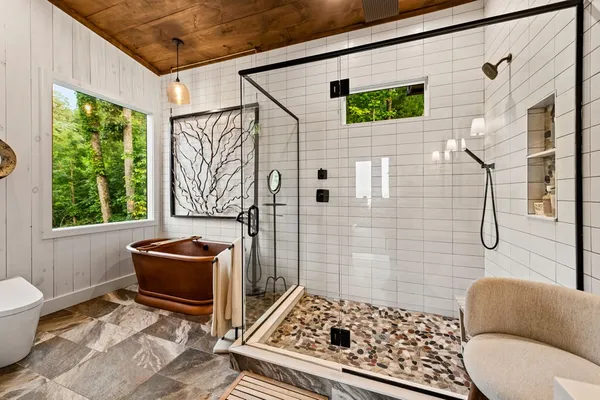 a bathroom with double vanity sinks and a shower
