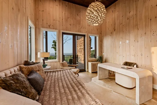 a living room with furniture and large windows