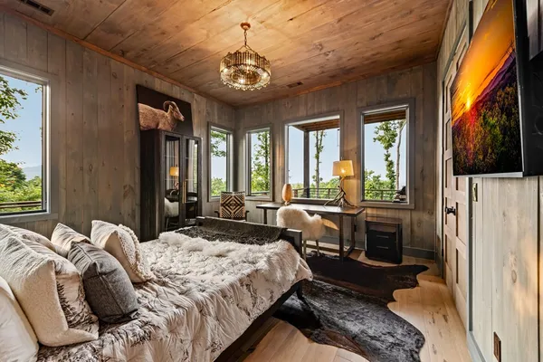 a bedroom with a bed and a large window