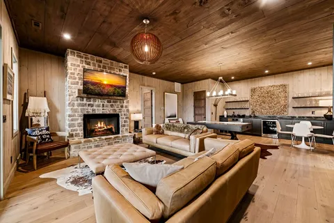 a living room with furniture flat screen tv and a fireplace