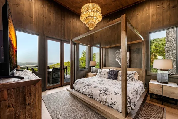 a bedroom with a large bed and a large window