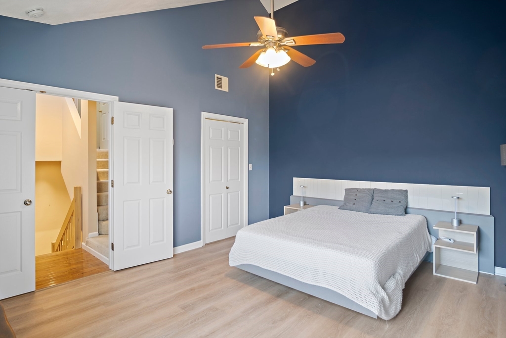 3 Mariners Way, Unit 3 Salem, MA 01970 - Photo 19 of 37 a bedroom with a bed and a chandelier