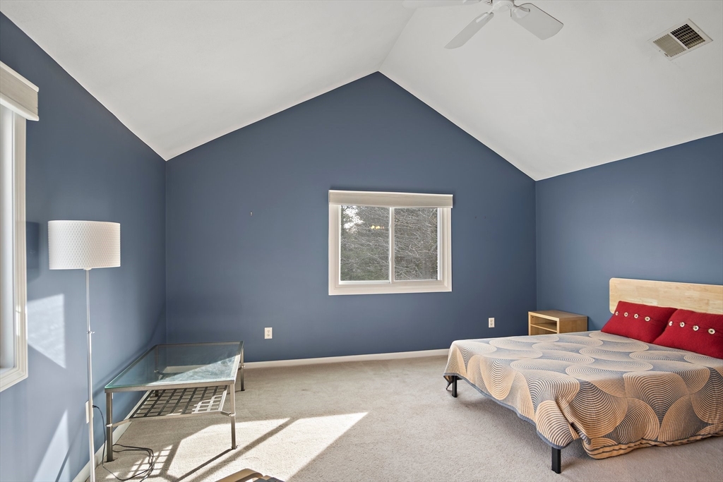 3 Mariners Way, Unit 3 Salem, MA 01970 - Photo 24 of 37 a bedroom with a bed and a lamp on table
