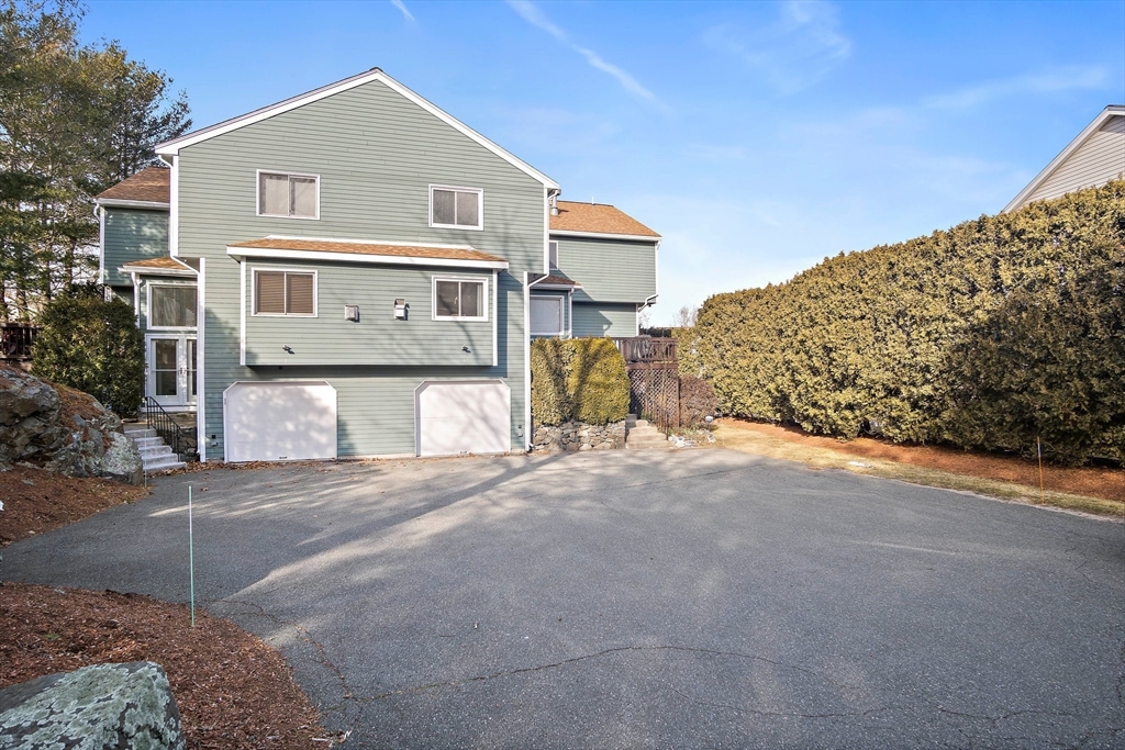 3 Mariners Way, Unit 3 Salem, MA 01970 - Photo 31 of 37 a front view of a house with a yard and garage
