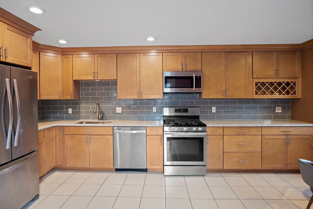 3 Mariners Way, Unit 3 Salem, MA 01970 - Photo 4 of 37 a kitchen with stainless steel appliances granite countertop a stove a sink and a microwave