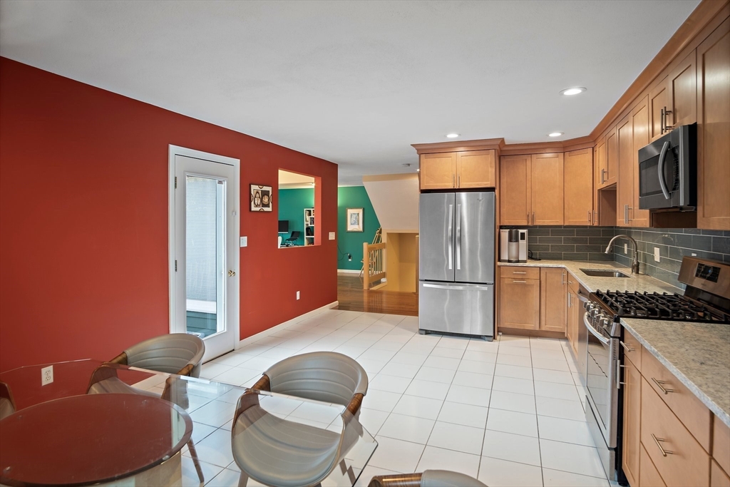 3 Mariners Way, Unit 3 Salem, MA 01970 - Photo 10 of 37 a kitchen with stainless steel appliances granite countertop a refrigerator a stove a sink and a microwave
