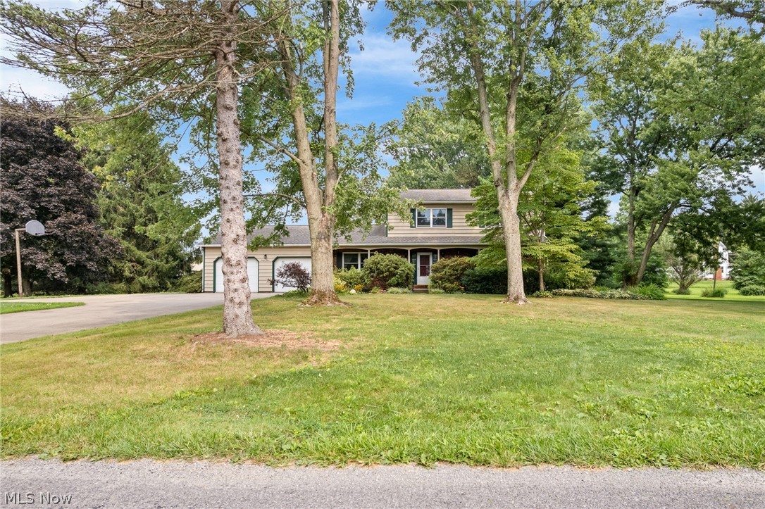 34 Kehner Road Mogadore, OH 44260 - Photo 1 of 40 Two-story residence with a covered porch, two-car garage, and mature trees situated on a spacious lawn