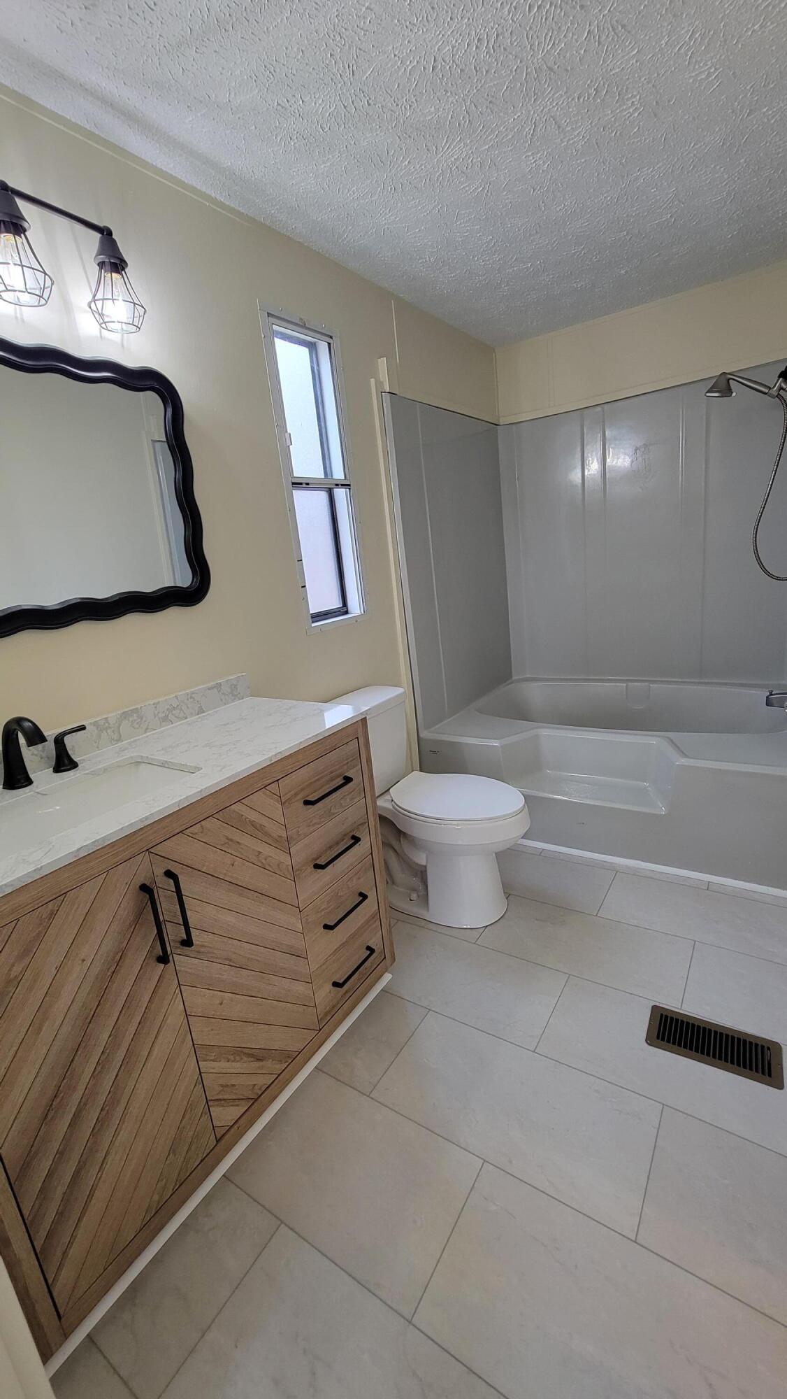 4350 Mountain View Church Road Blue Ridge, VA 24064 - Photo 11 of 30 a bathroom with a toilet a sink and mirror