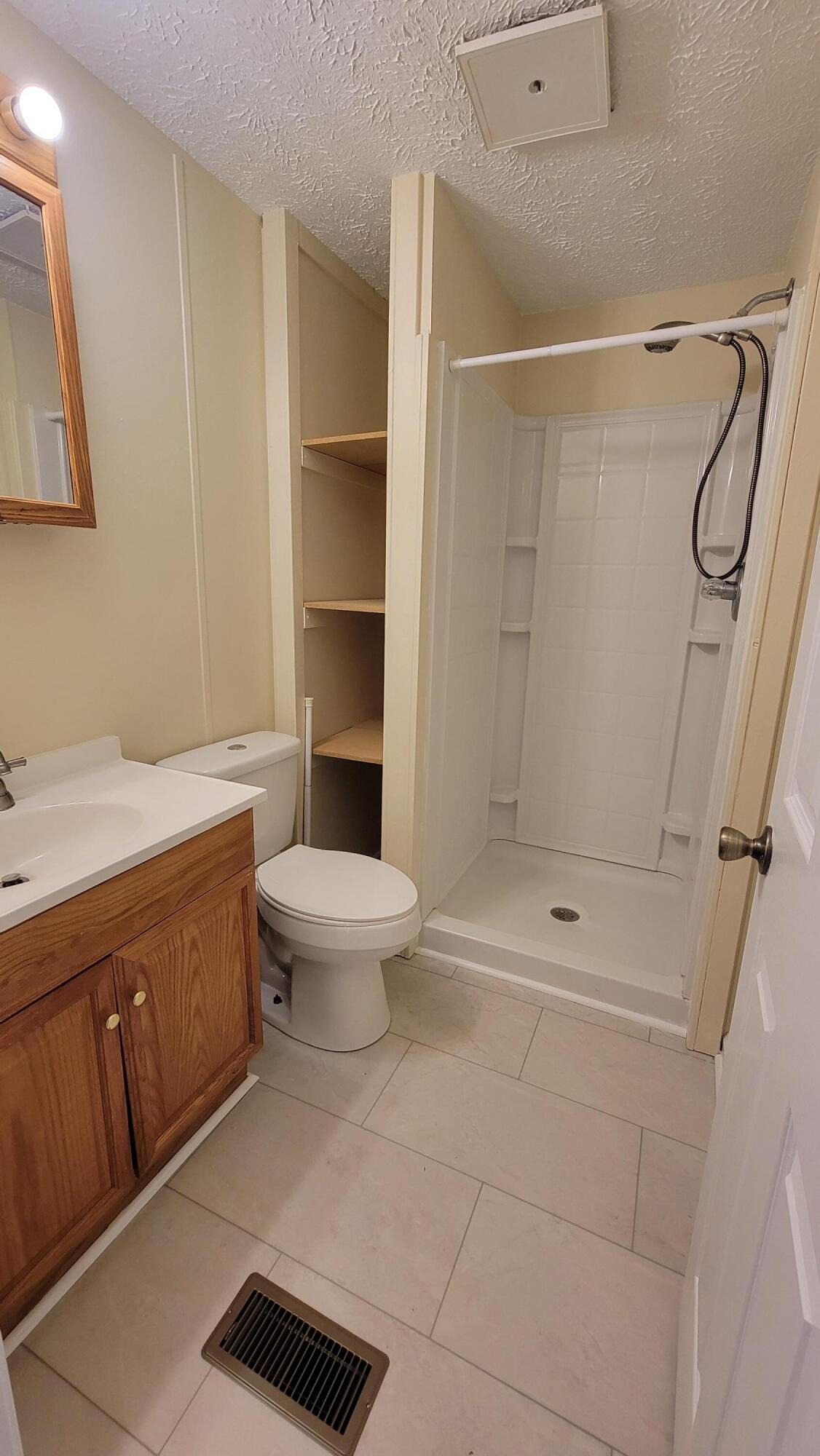 4350 Mountain View Church Road Blue Ridge, VA 24064 - Photo 15 of 30 a bathroom with a granite countertop sink a toilet and shower