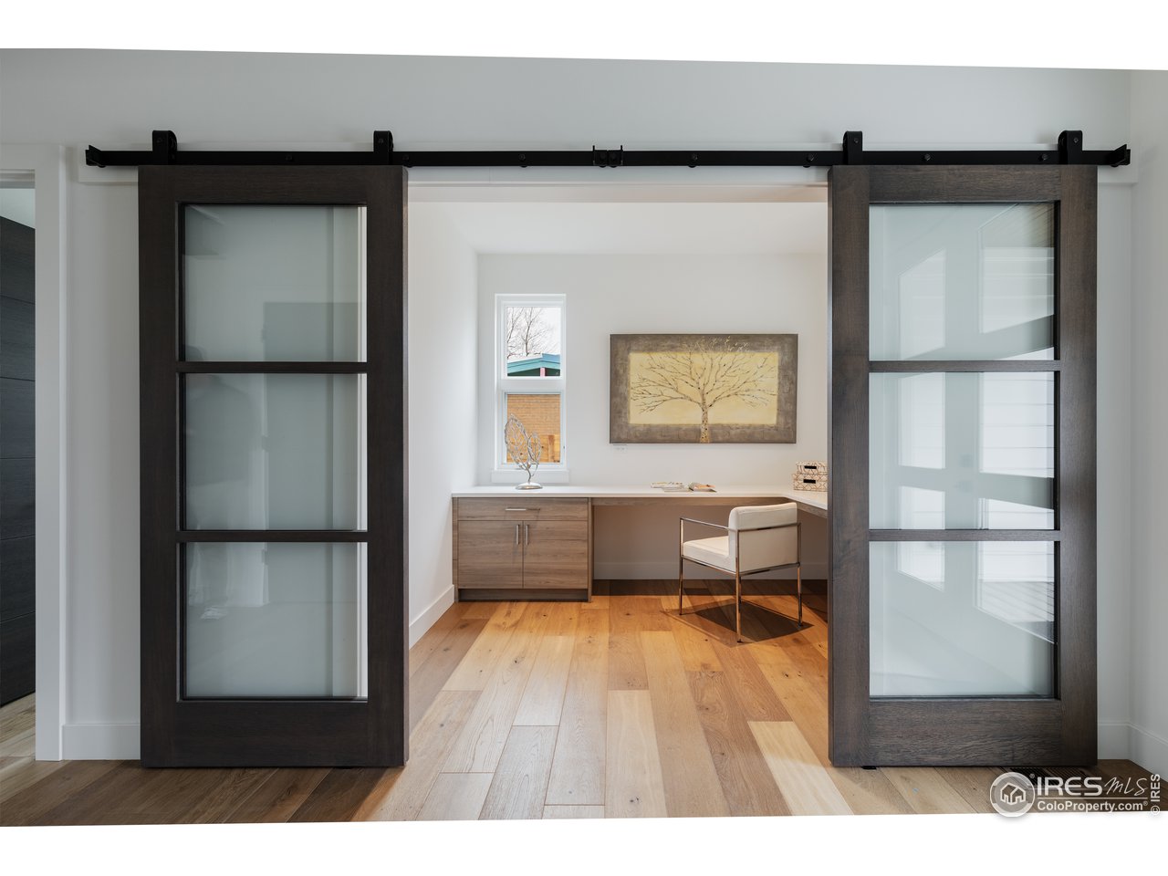 3025 18th Street Boulder, CO 80304 - Photo 13 of 35 a living room with a wooden floor and a window