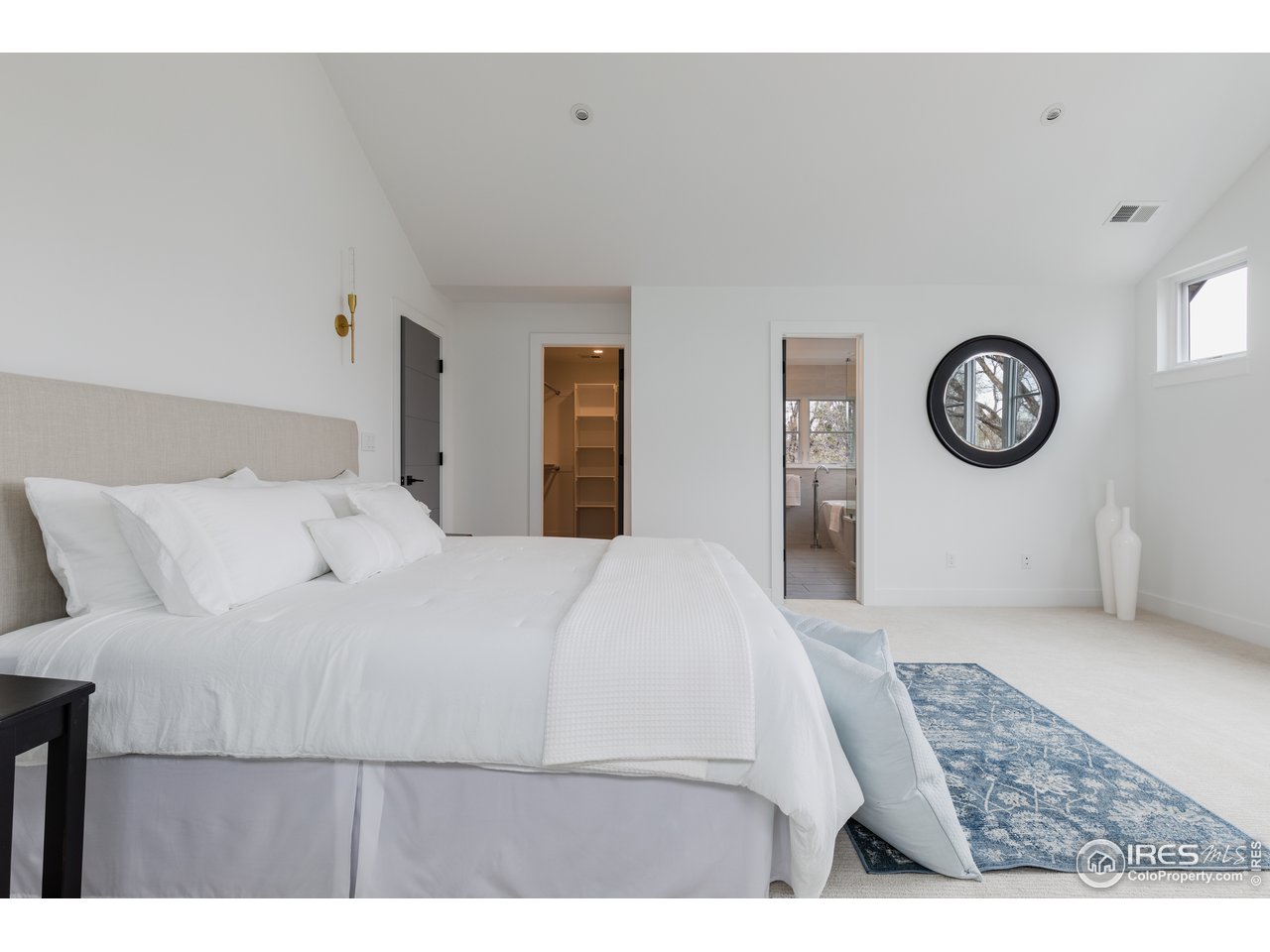 3025 18th Street Boulder, CO 80304 - Photo 20 of 35 a bedroom with a bed and a lamp on dresser
