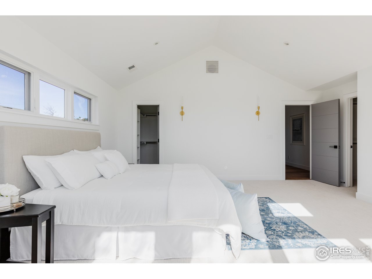 3025 18th Street Boulder, CO 80304 - Photo 21 of 35 a bedroom with a bed and a mirror