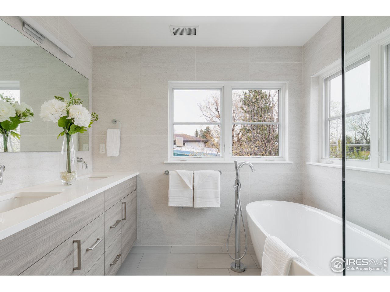 3025 18th Street Boulder, CO 80304 - Photo 29 of 35 a bathroom with a tub sink and mirror