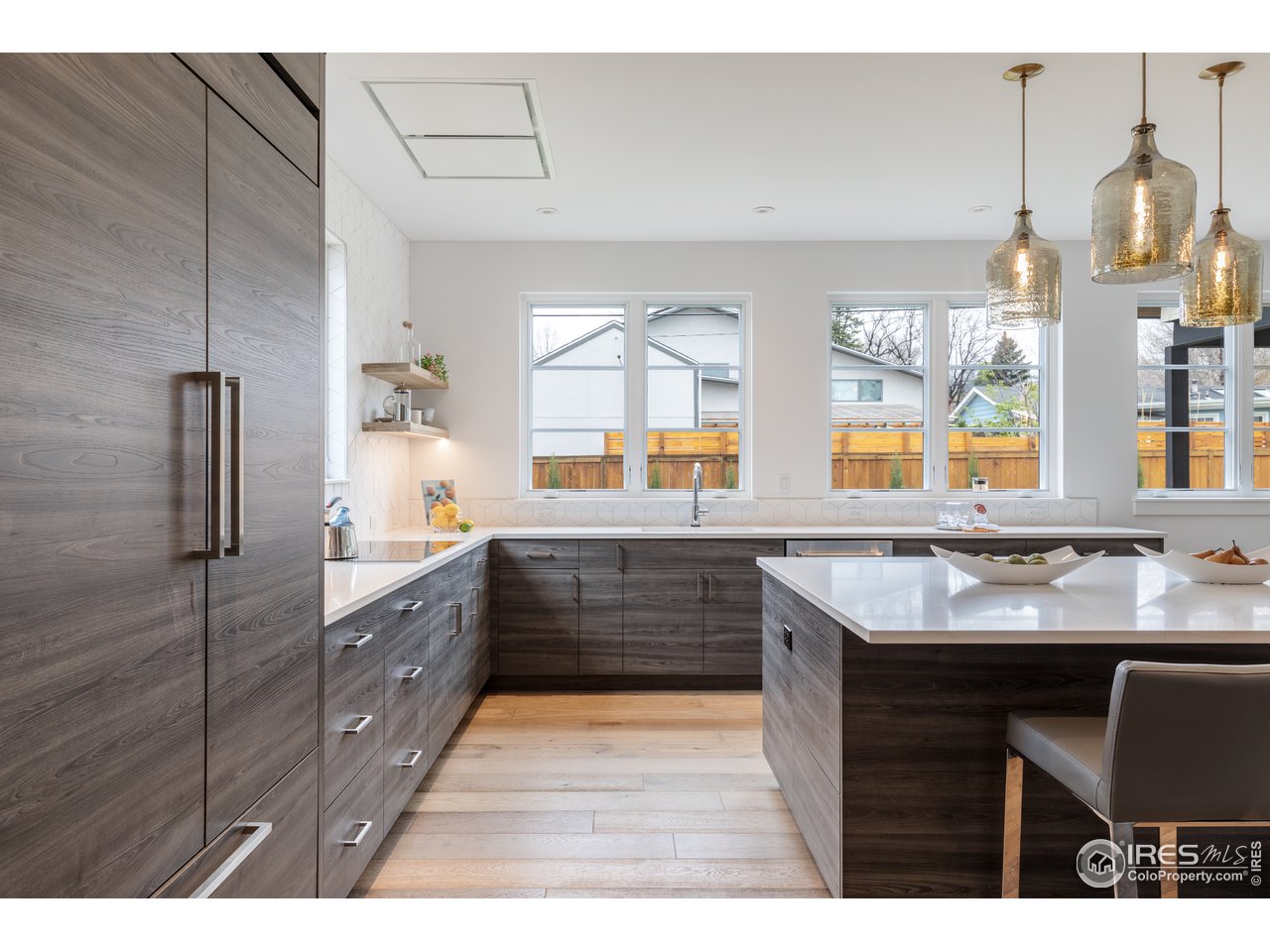 3025 18th Street Boulder, CO 80304 - Photo 5 of 35 a kitchen with stainless steel appliances kitchen island granite countertop a sink and wooden cabinets
