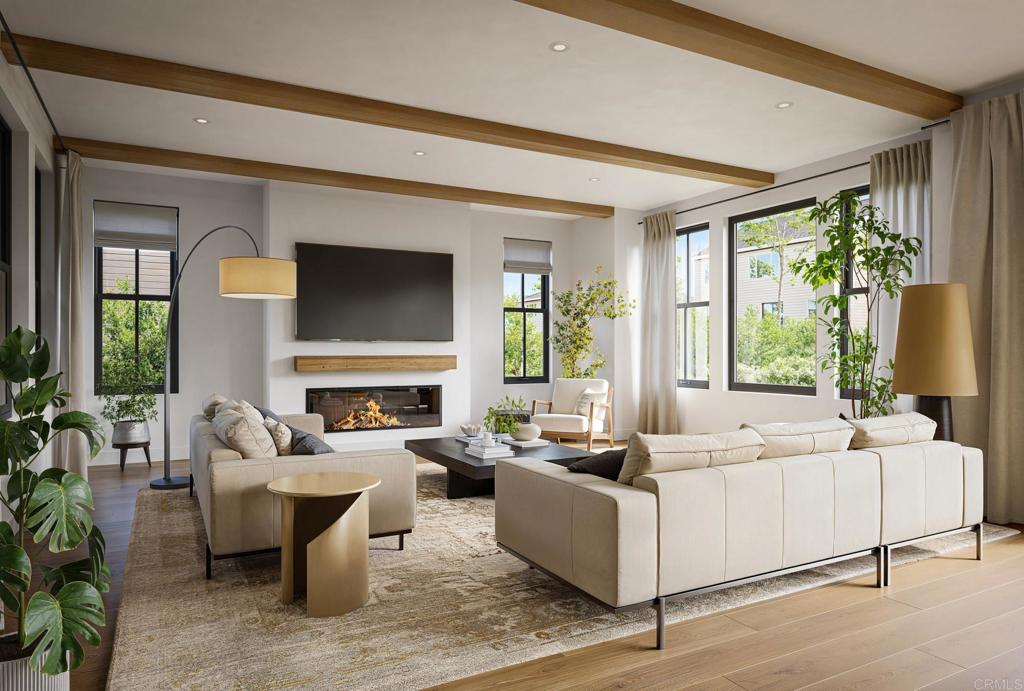 a living room with fireplace furniture and a large window