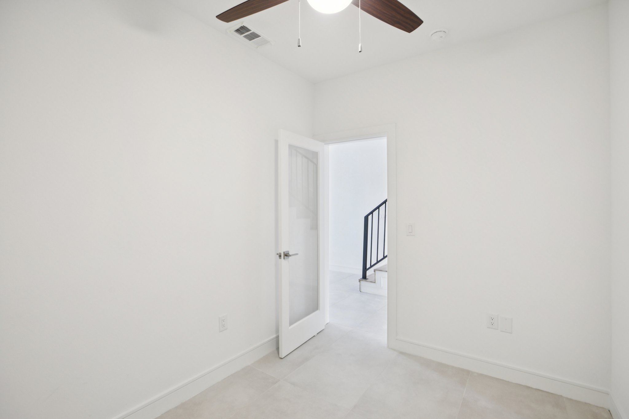 302 Tesla Circle Austin, TX 78681 - Photo 16 of 40 an empty room with a ceiling fan and carpet