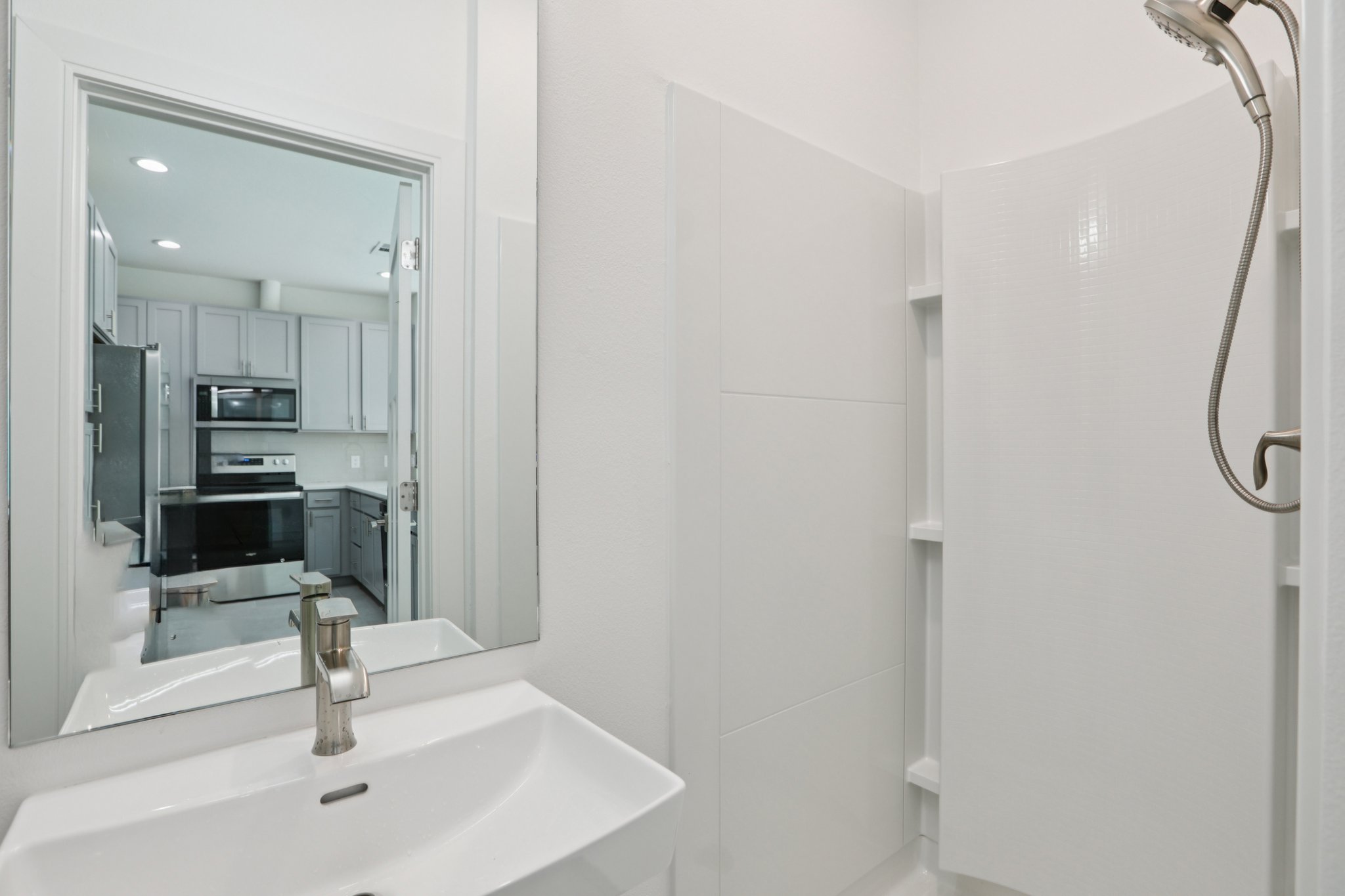302 Tesla Circle Austin, TX 78681 - Photo 18 of 40 a view of a bathroom with a sink and mirror