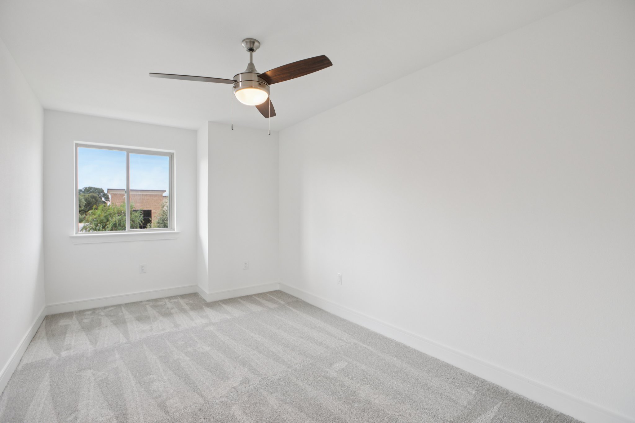 302 Tesla Circle Austin, TX 78681 - Photo 26 of 40 an empty room with a window and a ceiling fan