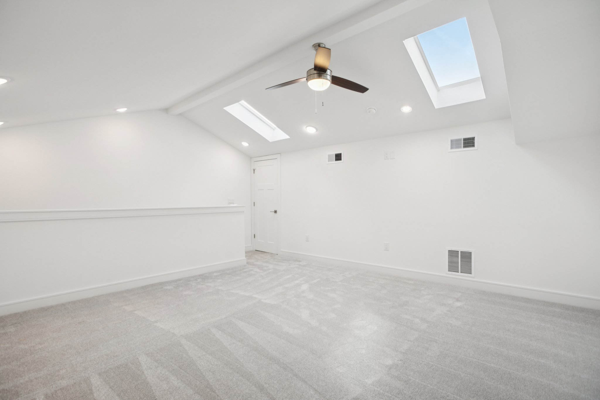 302 Tesla Circle Austin, TX 78681 - Photo 37 of 40 an empty room with projector and kitchen view