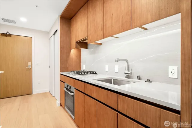 a kitchen with a sink and a refrigerator