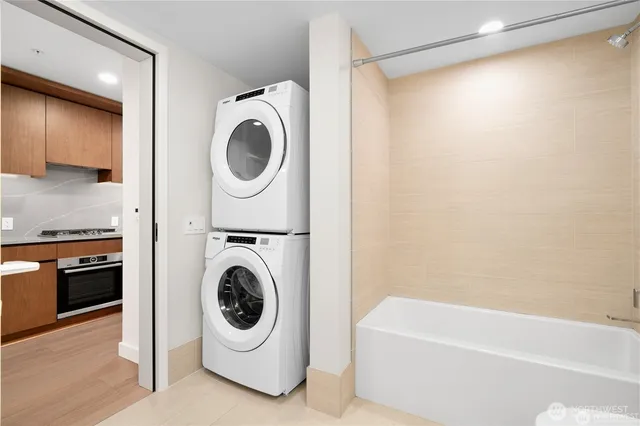 a utility room with sink dryer and washer