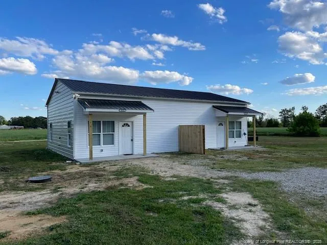 a view of a house with yard and a garden