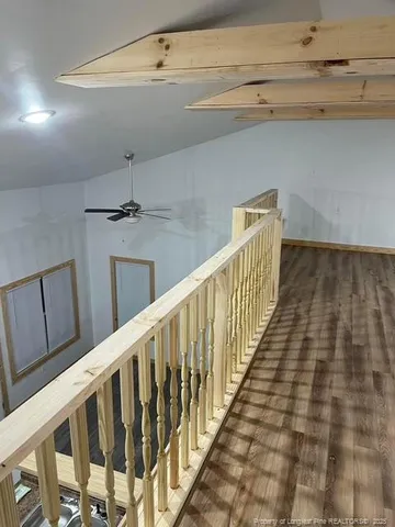 a view of a room with wooden floor