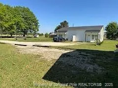 a backyard of a house with lots of green space