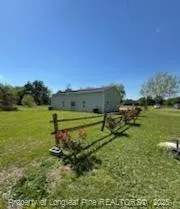 a view of house with trees in the background