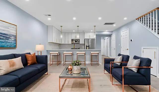 a living room with furniture and kitchen view