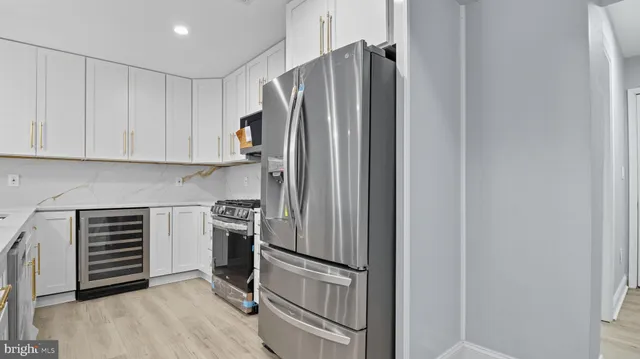 a kitchen with a refrigerator and cabinets