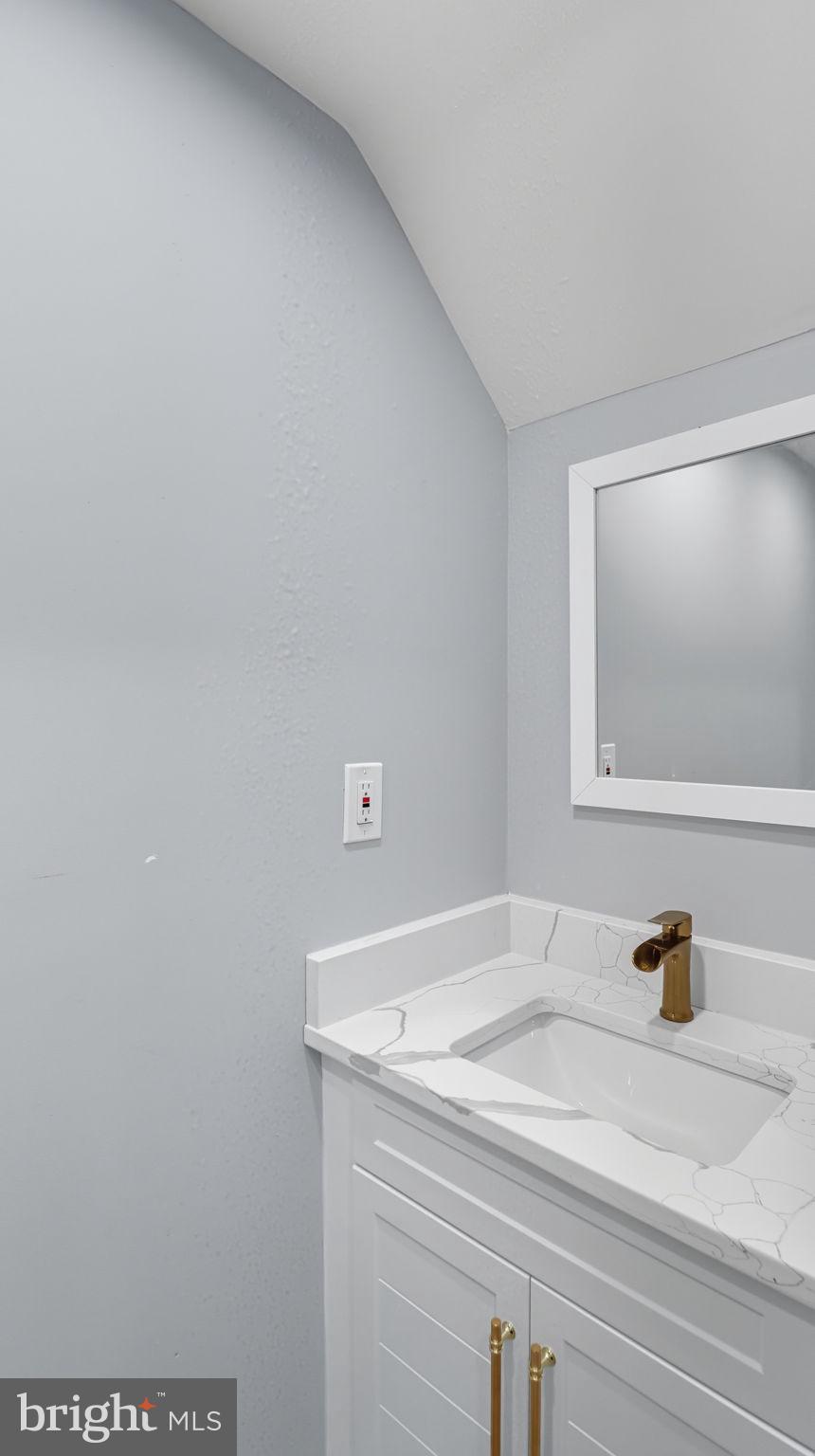 2238 15th Street Northeast Washington, DC 20018 - Photo 14 of 38 a bathroom with a sink and vanity